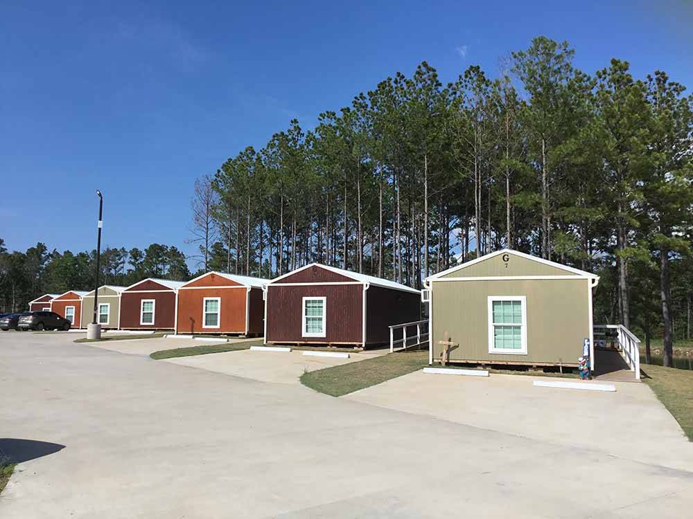 A row of rental cabins at BLUE SKY LAKE LIVINGSTON RV PARK & CABINS