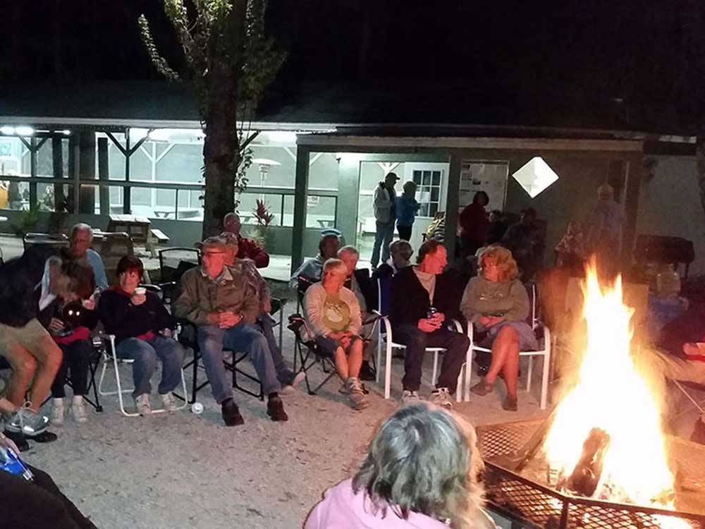 Group of people sitting around campfire at SEMINOLE CAMPGROUND