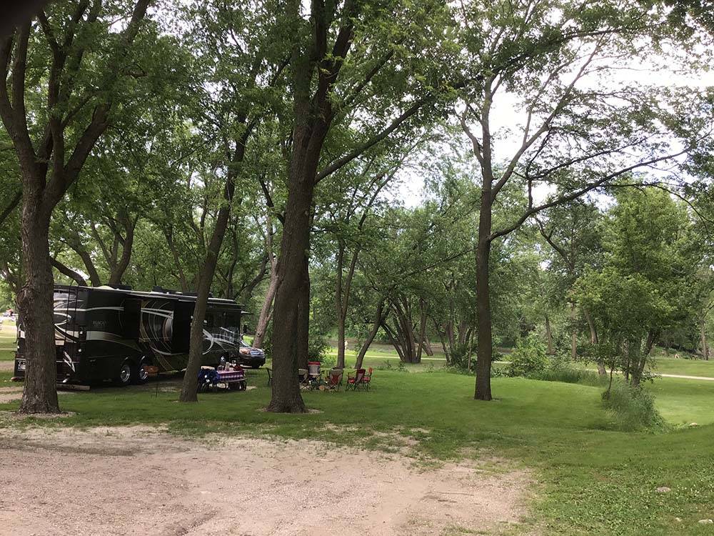 Open RV site with Class A Motorhome in distance at R CAMPGROUND
