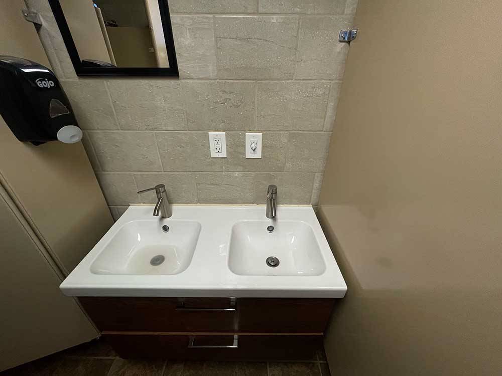 The clean bathroom sinks at WAGONS WEST RV PARK AND CAMPGROUND