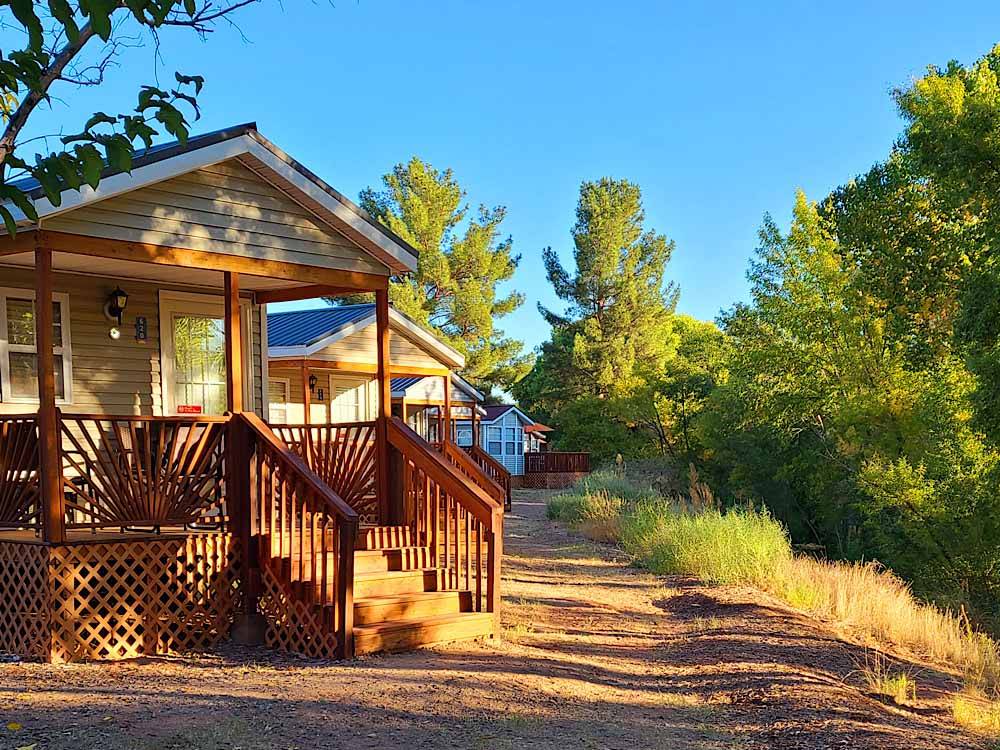 A row of rental cabins at VERDE RIVER RV RESORT & COTTAGES