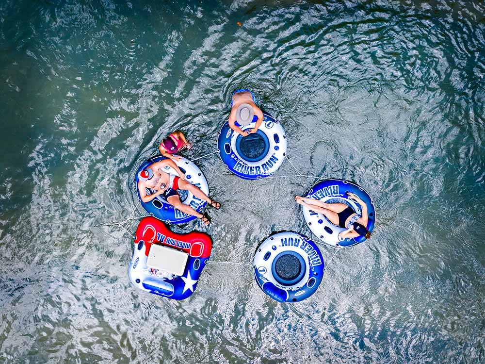 An aerial view of people on inner tubes on the river at SUMMIT VACATION & RV RESORT