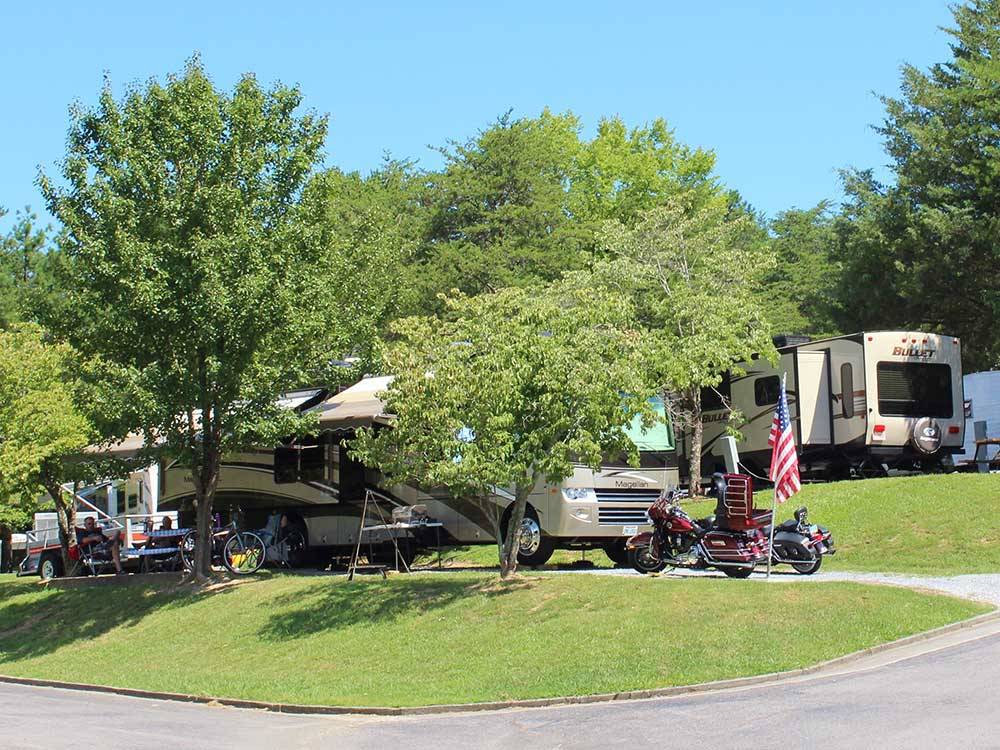 Campsite with big rig and 2 motorcycles at MILL CREEK RV PARK & VACATION RENTALS