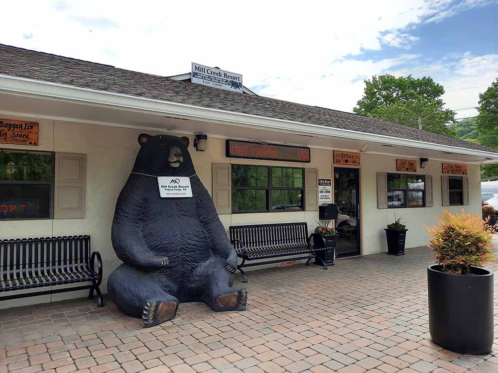 A statue of a bear in front of the office building at MILL CREEK RV PARK & VACATION RENTALS