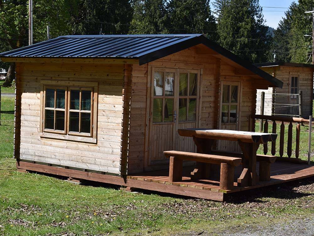 Small cabin with picnic table and porch at RAINIER WINGS / PACKWOOD RV PARK