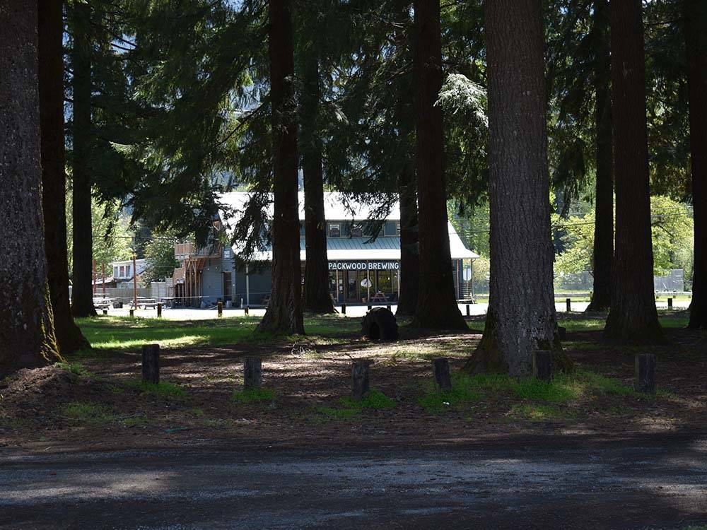 View of two-story campground building through trees at RAINIER WINGS / PACKWOOD RV PARK