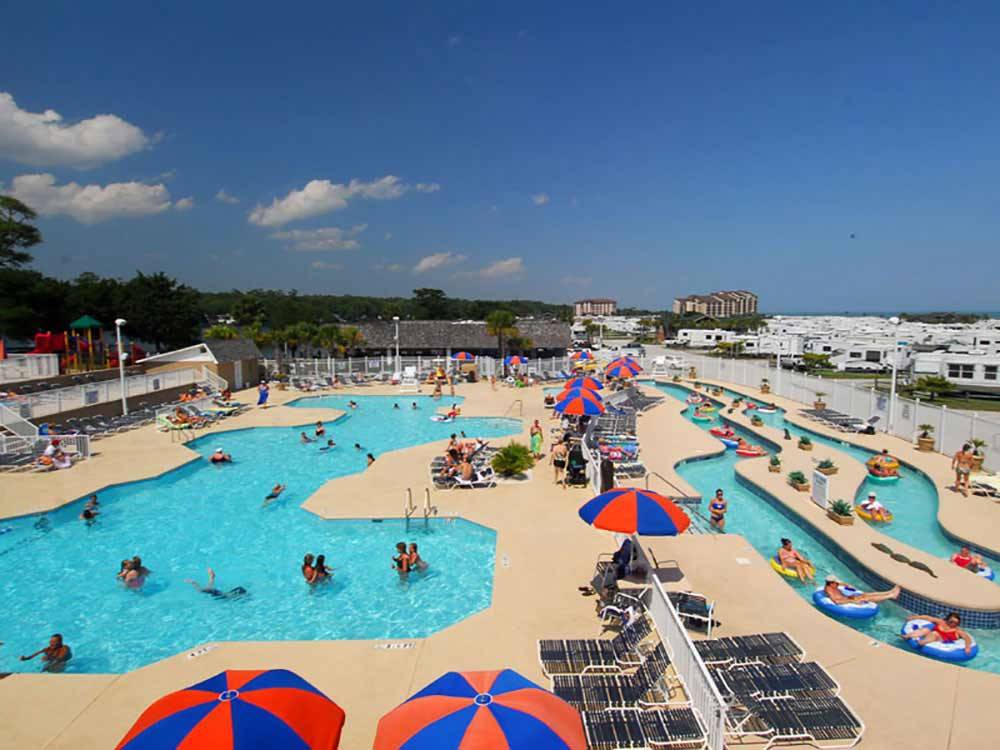 Swimming pool with umbrellas at MYRTLE BEACH CAMPGROUNDS