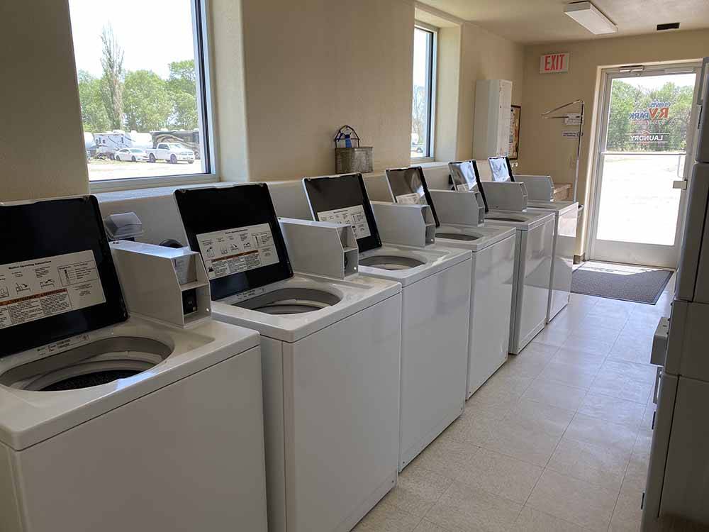 Row of clothes washers in room with windows at CLOVIS RV PARK
