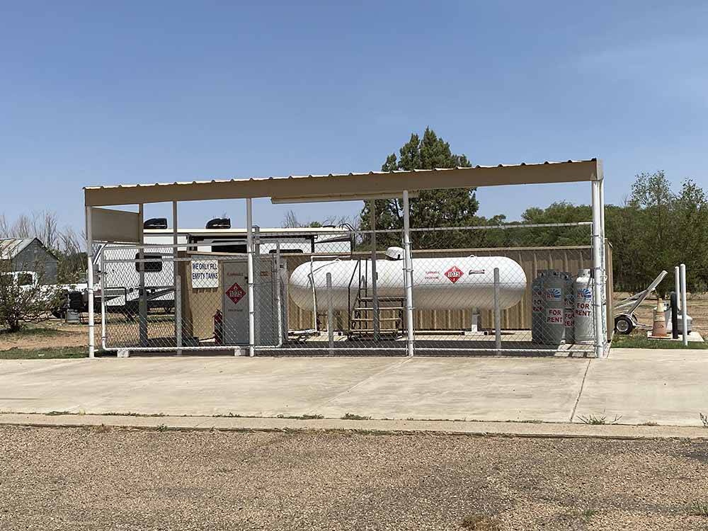 Large propane tank surrounded by fence at CLOVIS RV PARK