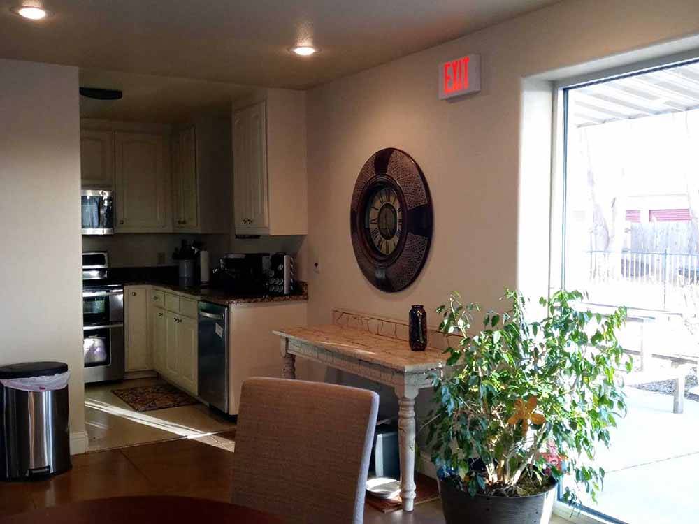 Kitchen area with plant and dining table at CLOVIS RV PARK
