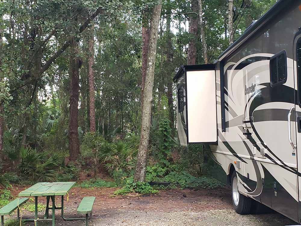A motorhome and a picnic table at CHASSAHOWITZKA RIVER CAMPGROUND