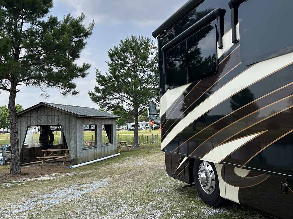 A motorhome parked next to the pavilion at FARM COUNTRY CAMPGROUND