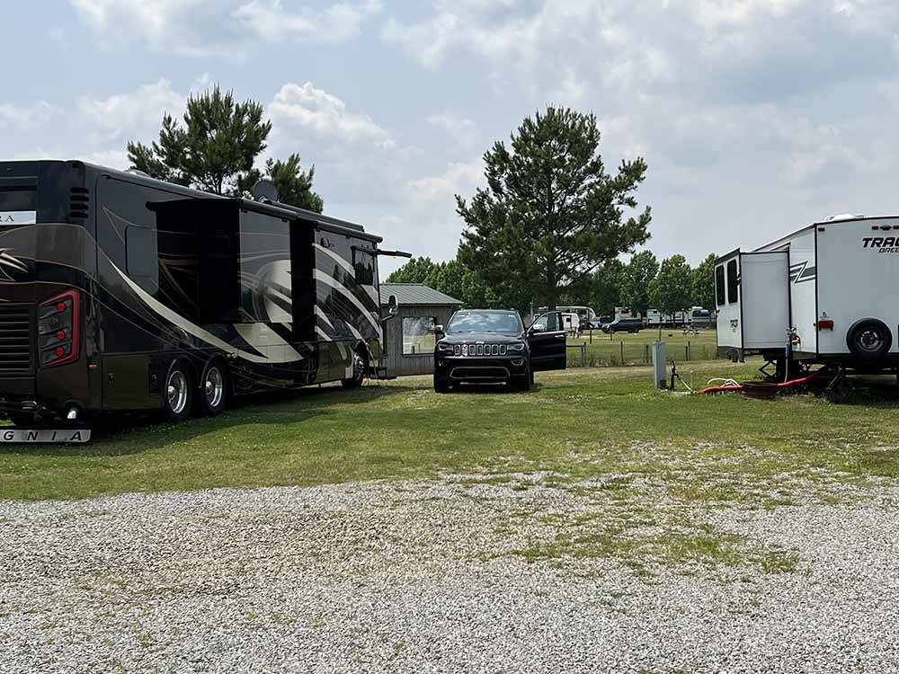 A motorhome and trailer parked at FARM COUNTRY CAMPGROUND