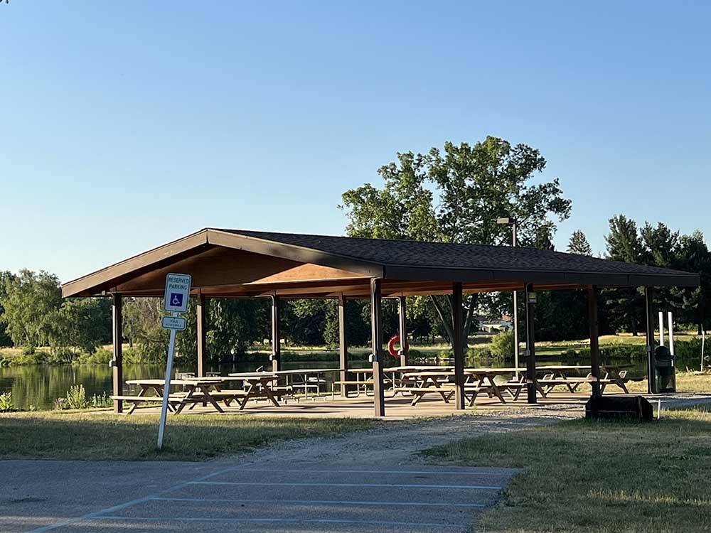 Pavilion with multiple picnic tables for gatherings at SOARING EAGLE HIDEAWAY RV PARK
