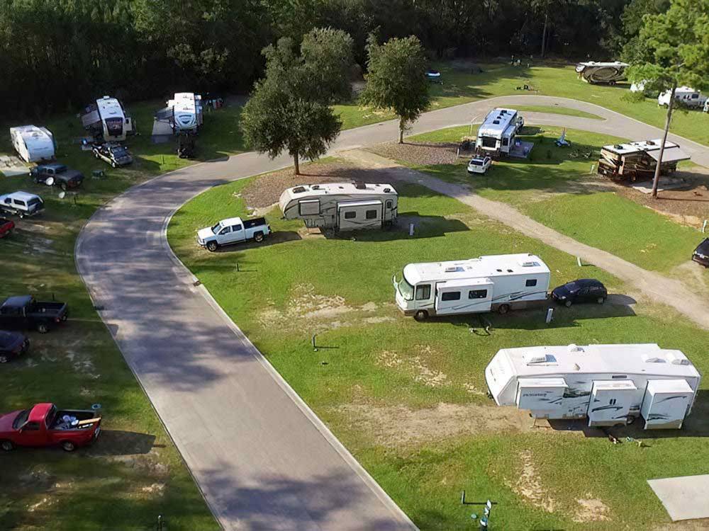 Aerial shot of motorhomes with fifth-wheels on grassy sites at LAKE JASPER RV VILLAGE