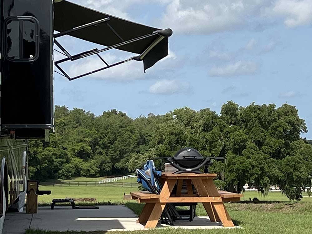 Picnic table and grill outside motorhome at GRAND OAKS RESORT