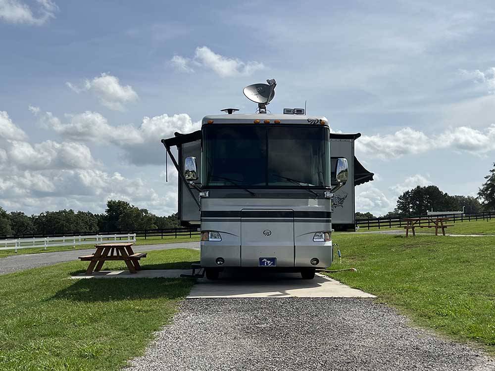 Front view of Class A motorhome at campsite at GRAND OAKS RESORT