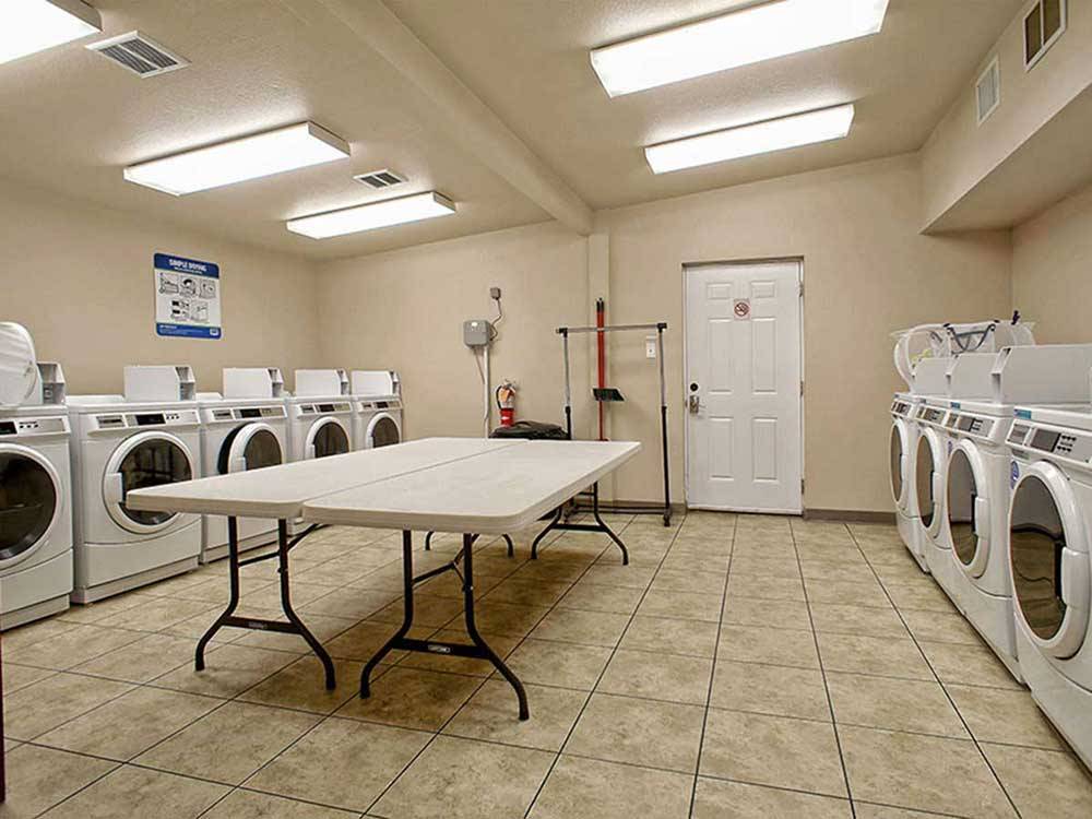 Laundry room with washer and dryers at SHADY CREEK RV PARK AND STORAGE