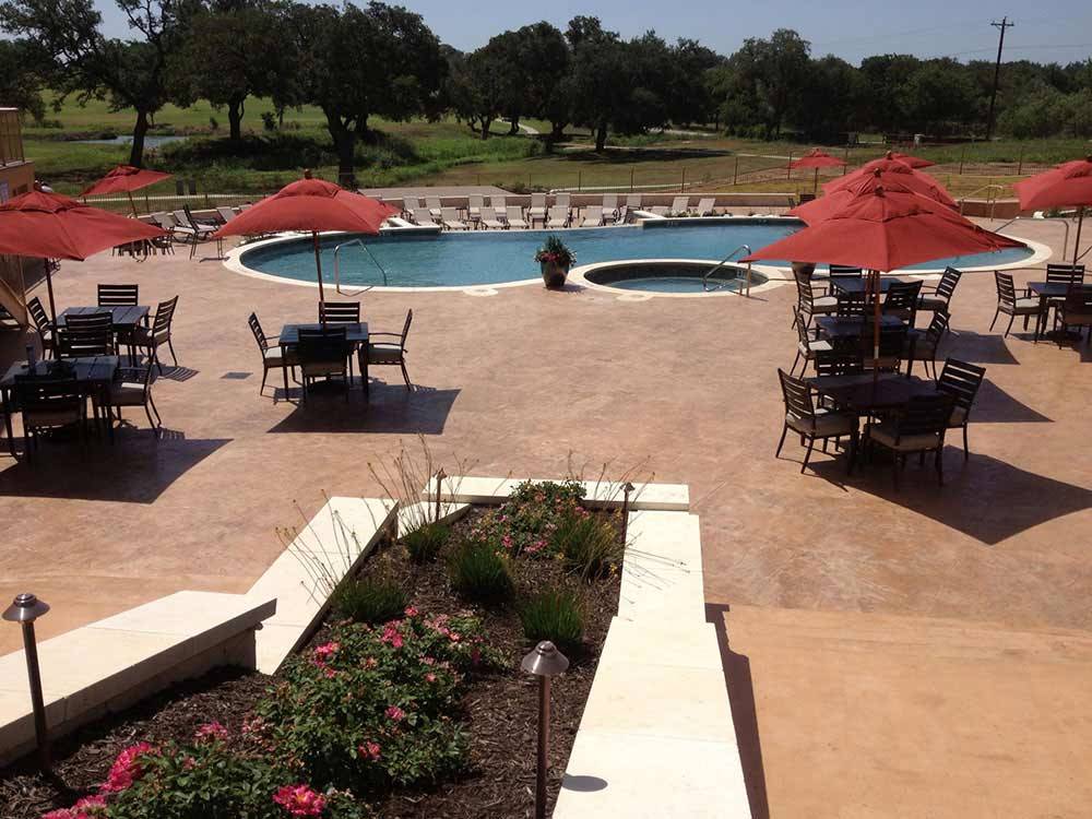 Swimming pool with outdoor seating at ALSATIAN RV RESORT & GOLF CLUB