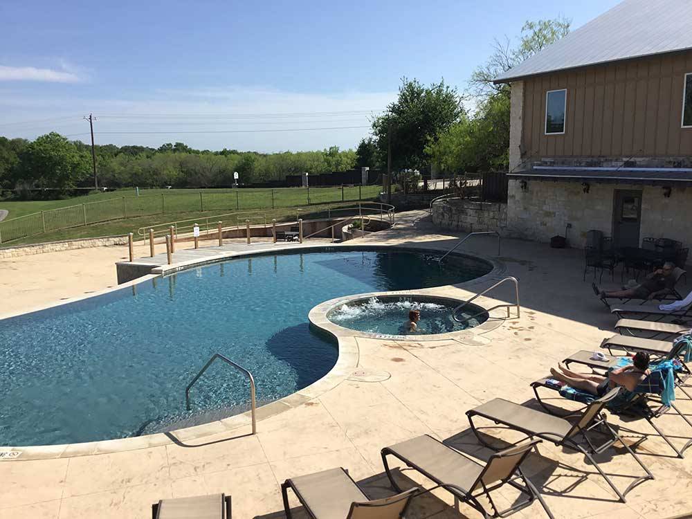Swimming pool and spa with lounges at ALSATIAN RV RESORT & GOLF CLUB