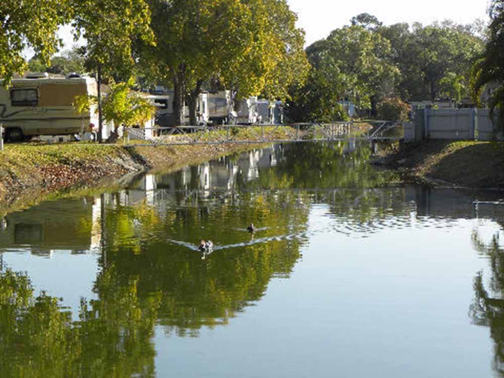 A row of trailers along the water at LAZY J RV & MOBILE HOME PARK