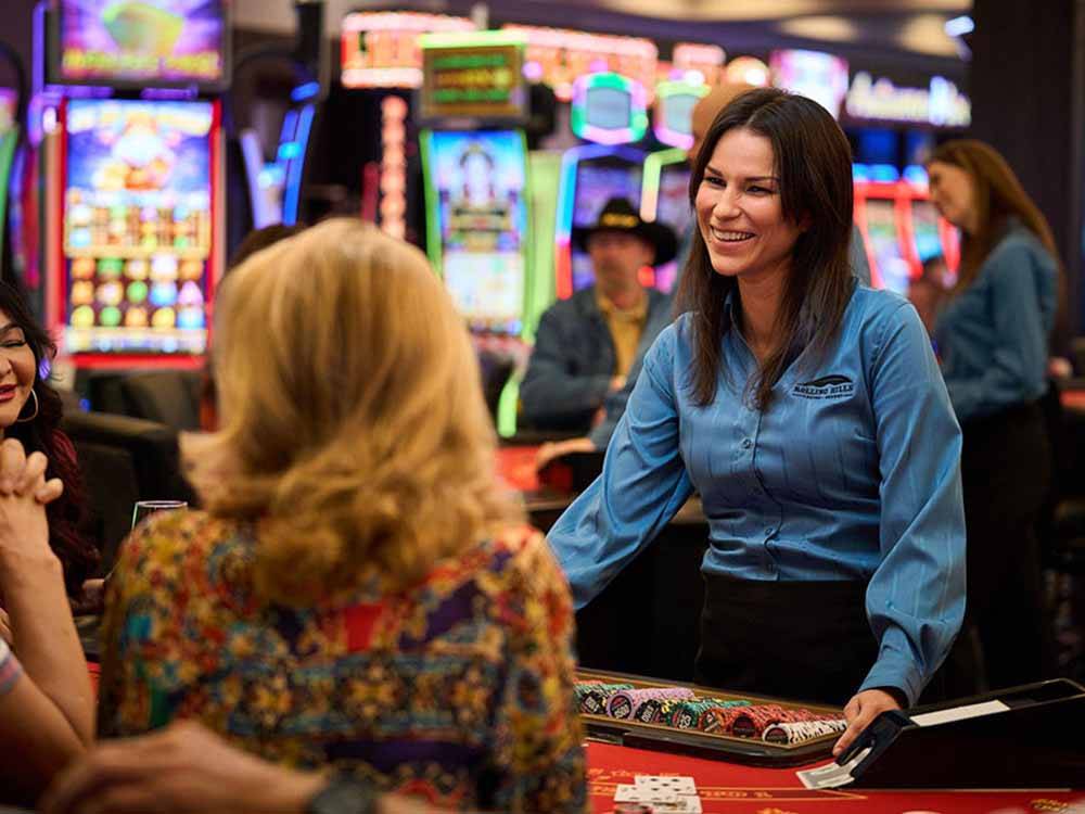 A blackjack dealer at a table at THE RV PARK AT ROLLING HILLS CASINO AND RESORT