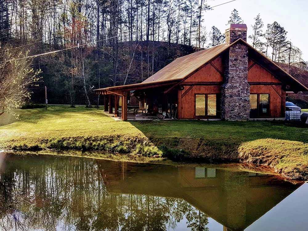A rustic building by the water at VALLEY RIVER RV RESORT