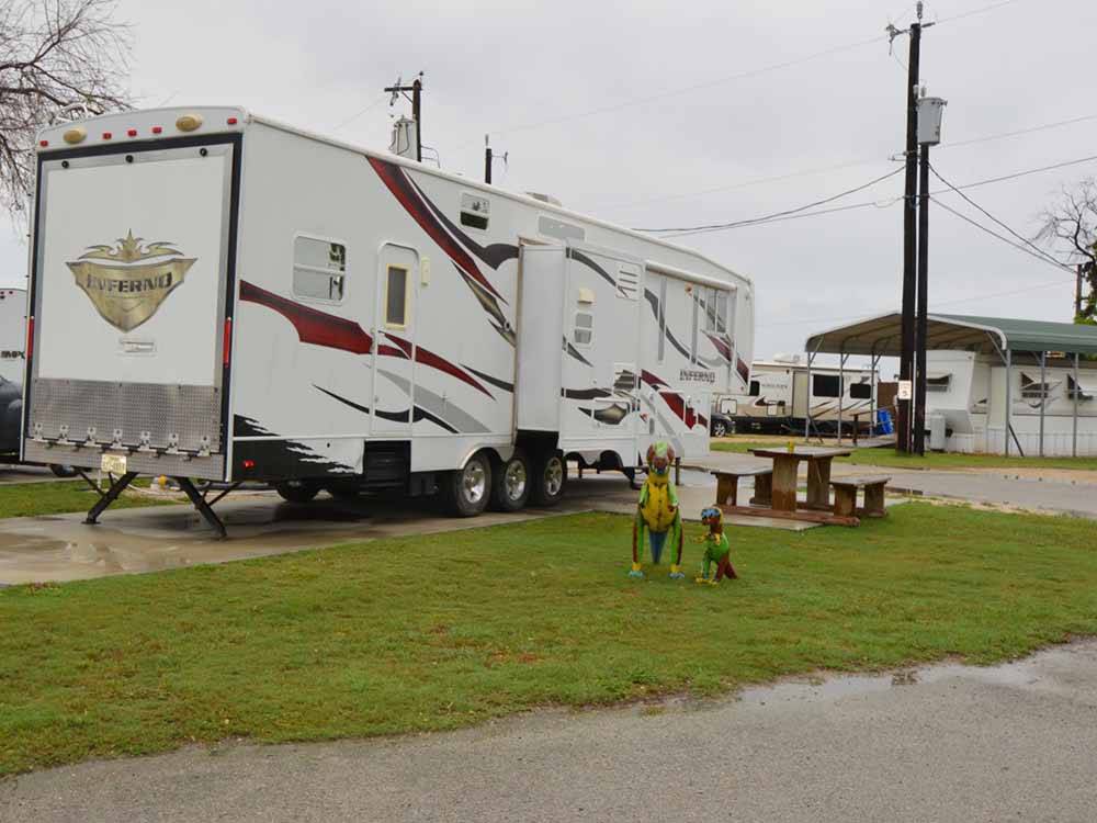 A fifth wheel trailer in a paved RV site at MISSION CITY RV PARK