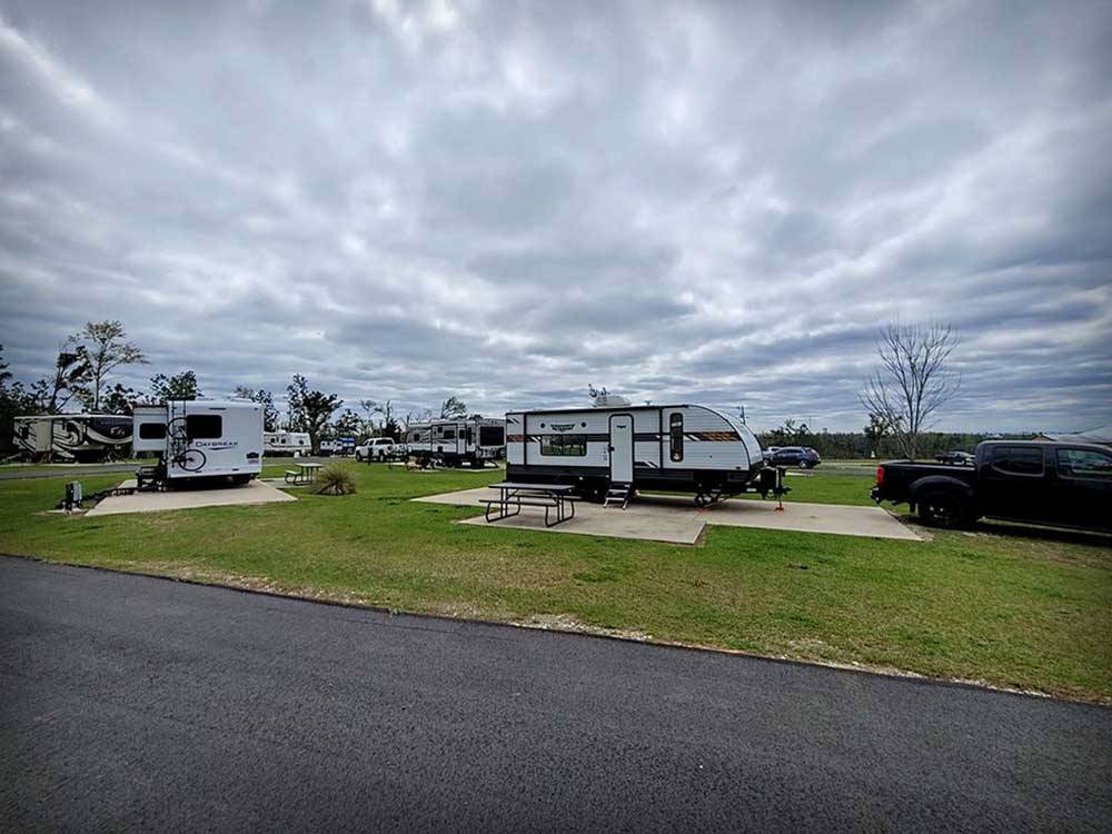 Several of the campsites, with campers at ALLIANCE HILL RV RESORT