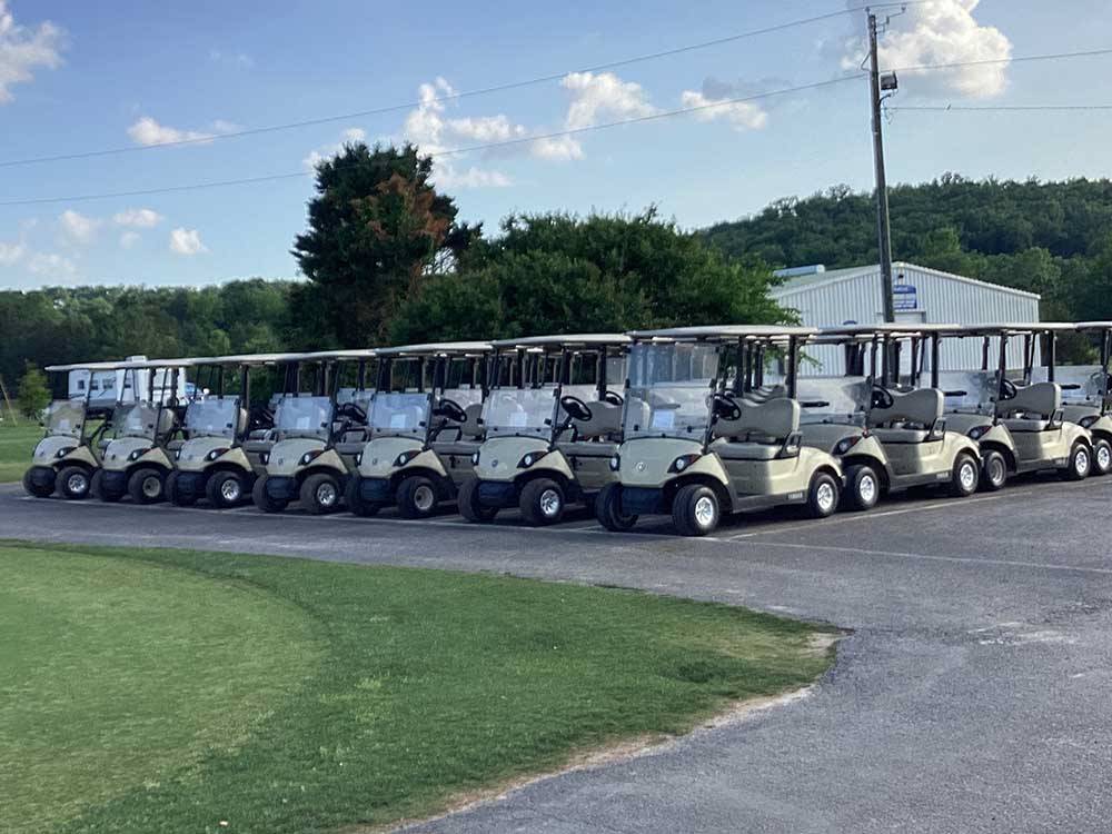 A bunch of golf carts parked at QUAIL CREEK RV RESORT