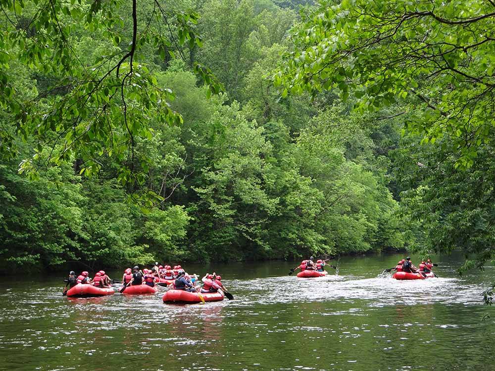 A group of people rafting down the river at PIGEON RIVER CAMPGROUND