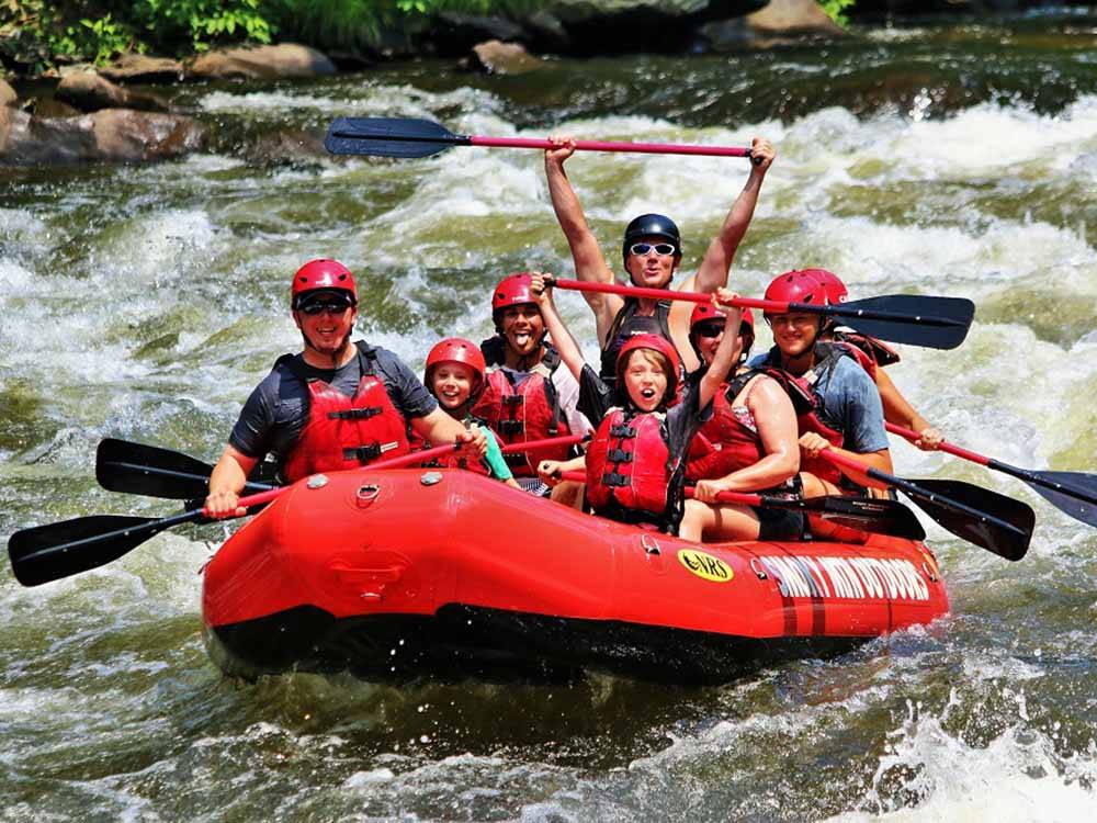 A group of people white water rafting at PIGEON RIVER CAMPGROUND