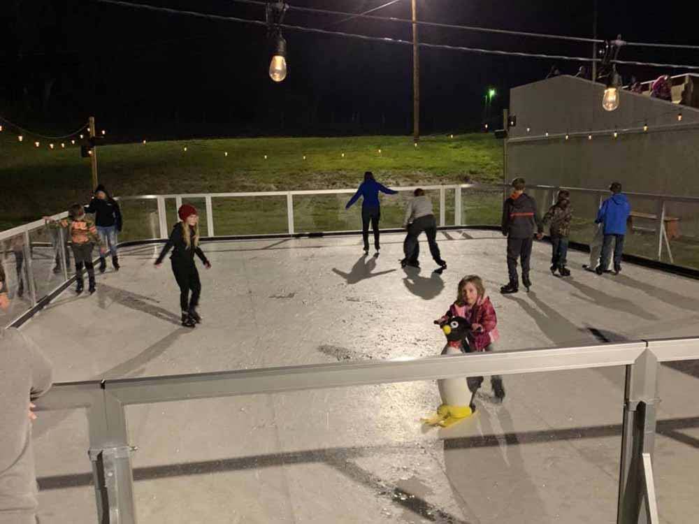 Families enjoying the ice skating rink at LAUREL LAKE CAMPING RESORT