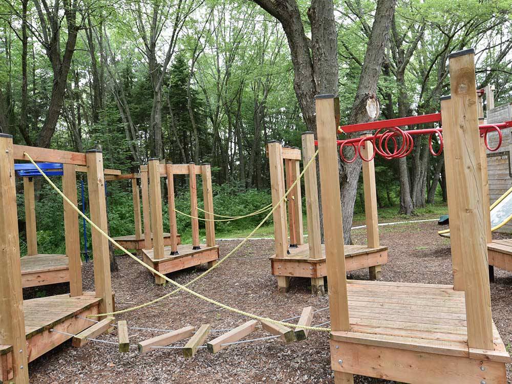 Wooden playground equipment at MAPLEWOOD ACRES RV PARK