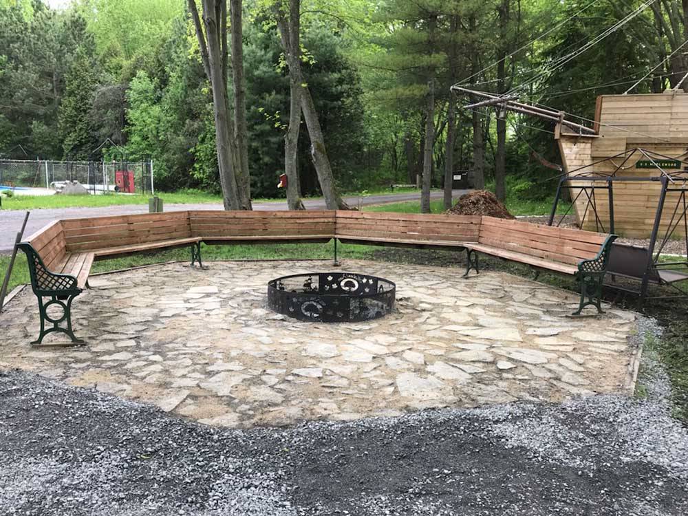 Benches placed in circle around fire pit at MAPLEWOOD ACRES RV PARK
