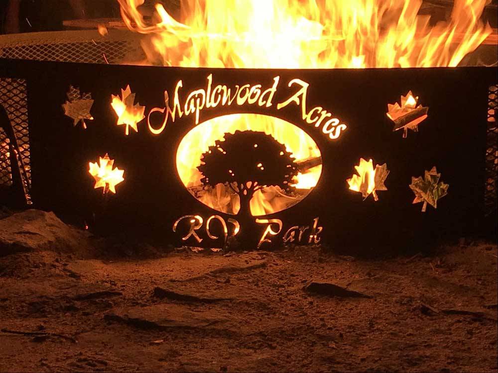 Large fire inside custom fire pit at MAPLEWOOD ACRES RV PARK