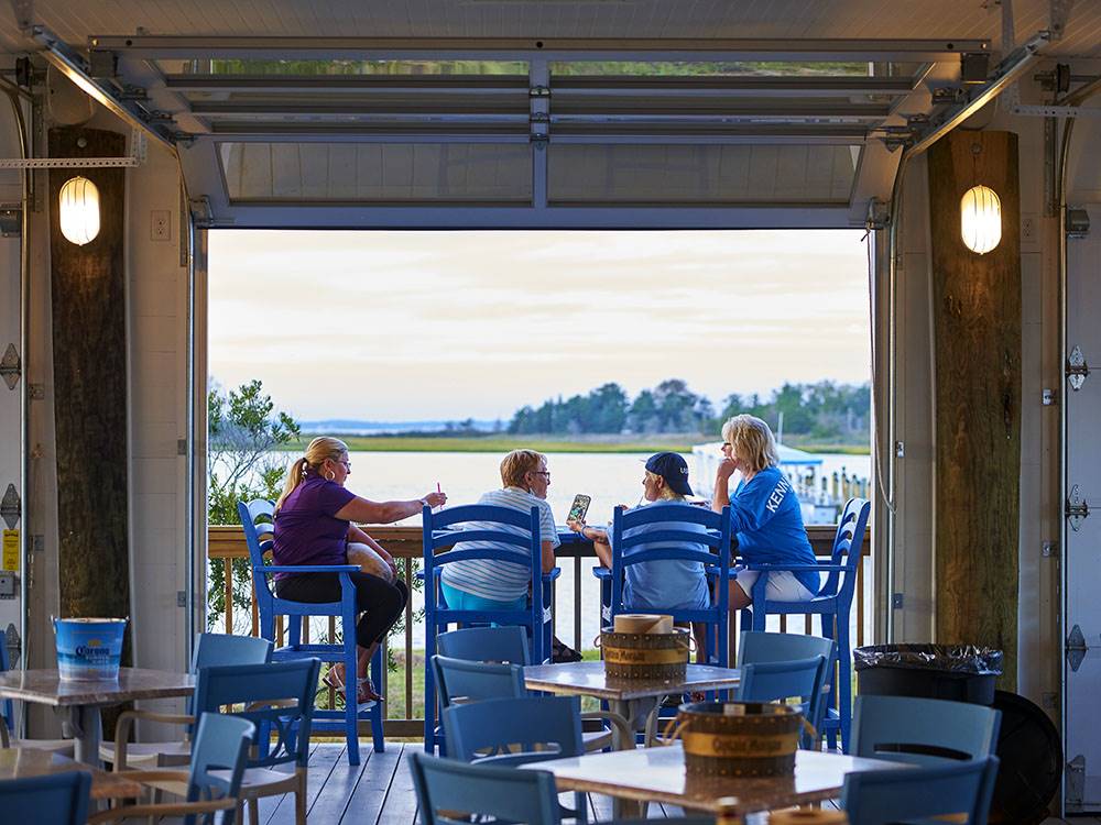 A family enjoying the lake view from a deck at SUN OUTDOORS REHOBOTH BAY