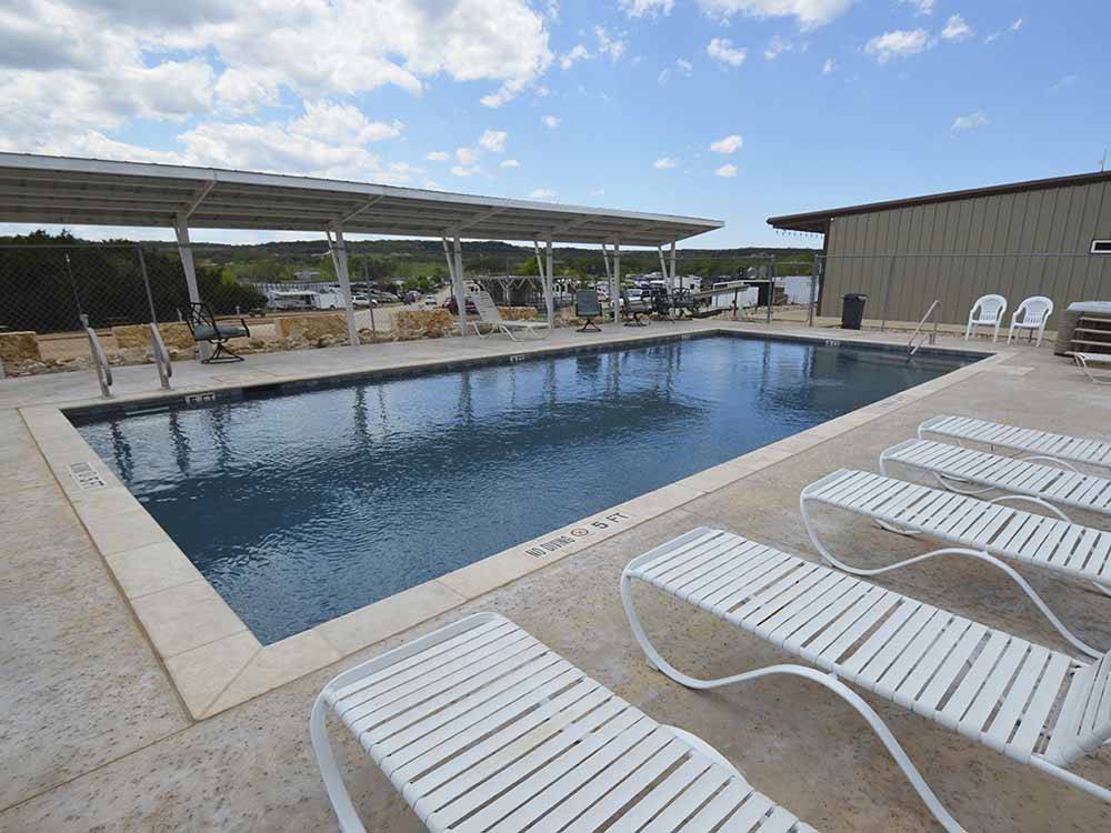 The swimming pool with lounge chairs at THE VINEYARDS OF FREDERICKSBURG RV PARK