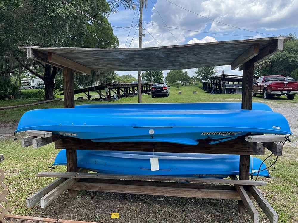 A rack of blue kayaks at SPORTSMAN'S COVE RESORT