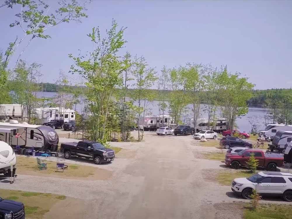 A group of RV sites by the water at CASTLE LAKE CAMPGROUND & COTTAGES
