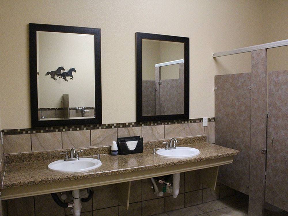 Bathrooms and sink area at WHISTLE STOP RV RESORT