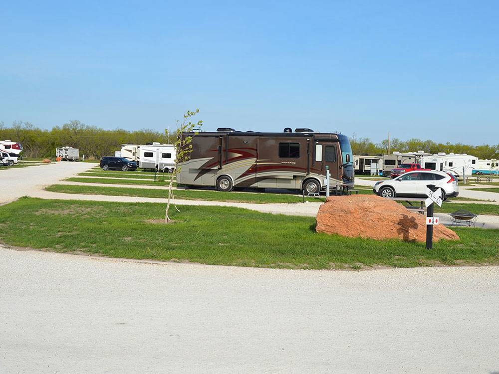 RVs and trailers at campground at WHISTLE STOP RV RESORT