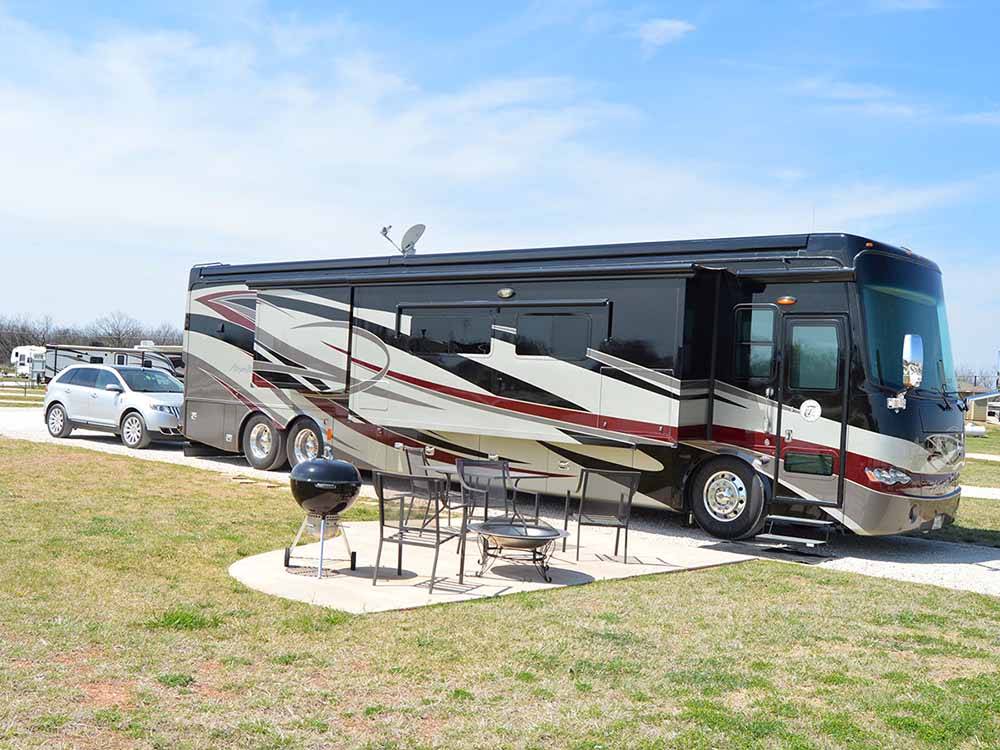 A big rig motorhome at one of the pull-thru sites at WHISTLE STOP RV RESORT