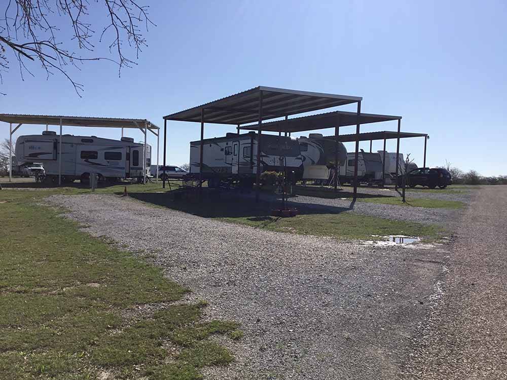 Several campers in covered campsites at WEST GATE RV PARK