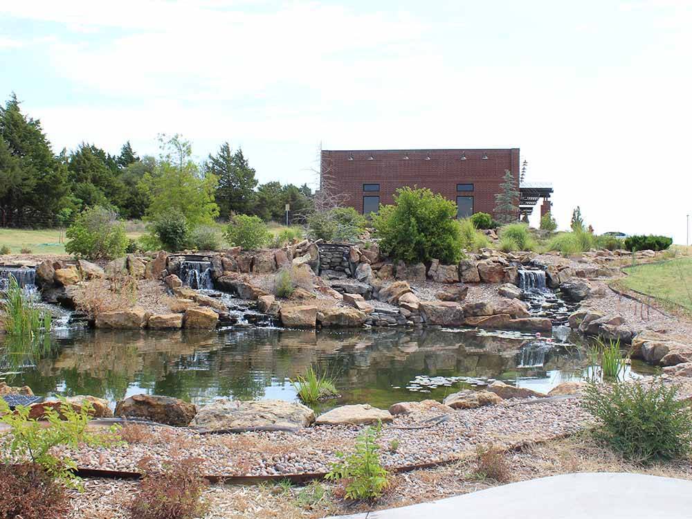 A waterfall and pond water feature at WANDERLUST CROSSINGS RV PARK