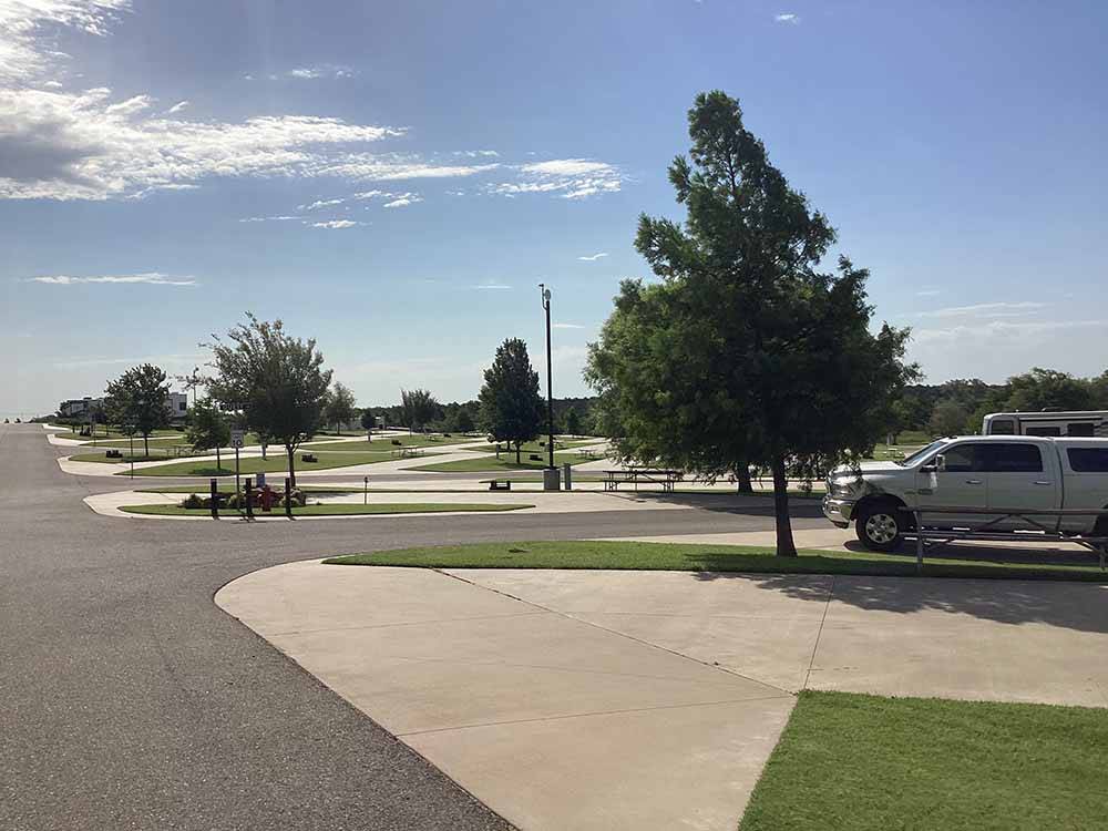 A row of paved sites at WANDERLUST CROSSINGS RV PARK