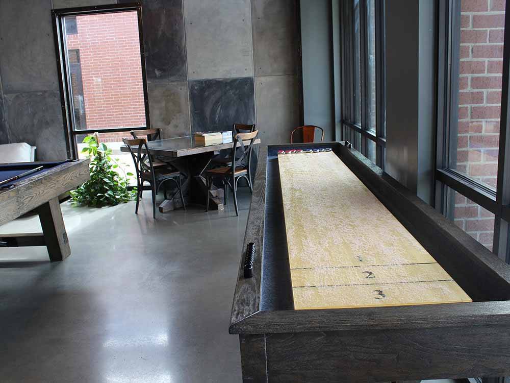 The indoor shuffleboard table at WANDERLUST CROSSINGS RV PARK