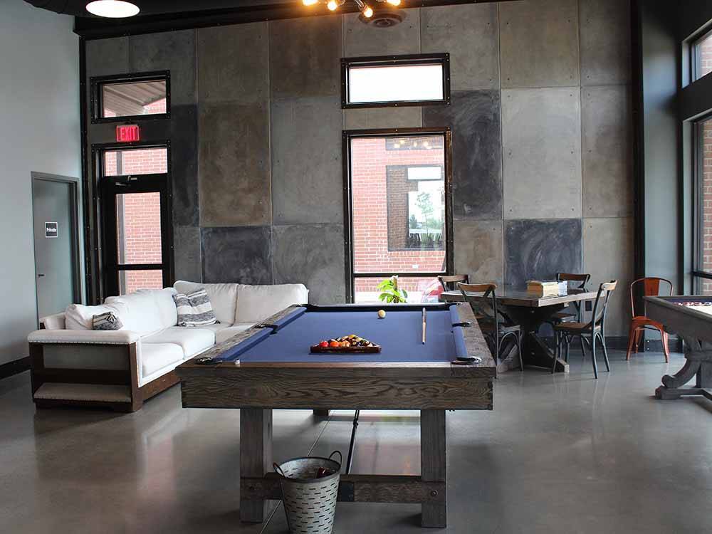 The pool table and seating area at WANDERLUST CROSSINGS RV PARK