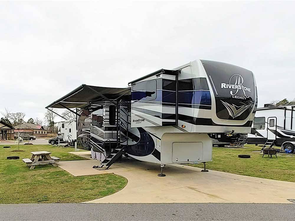 Fifth-wheel RV with slide-outs on an overcast day at NMB RV RESORT AND DRY DOCK MARINA