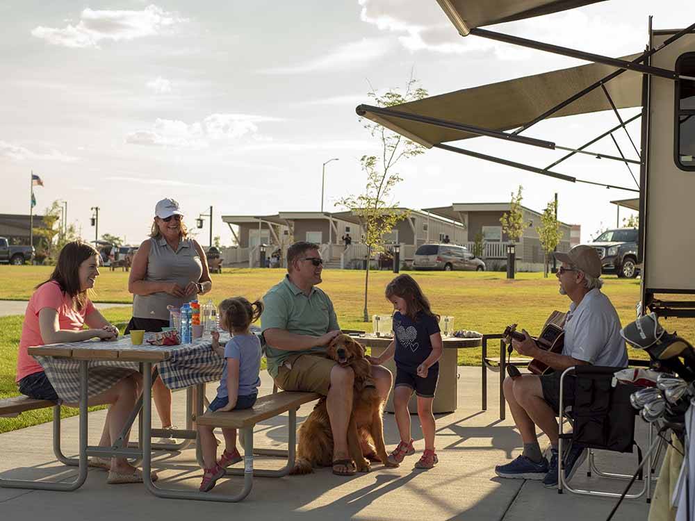 A family eating at their RV site at NORTHERN QUEST RV RESORT